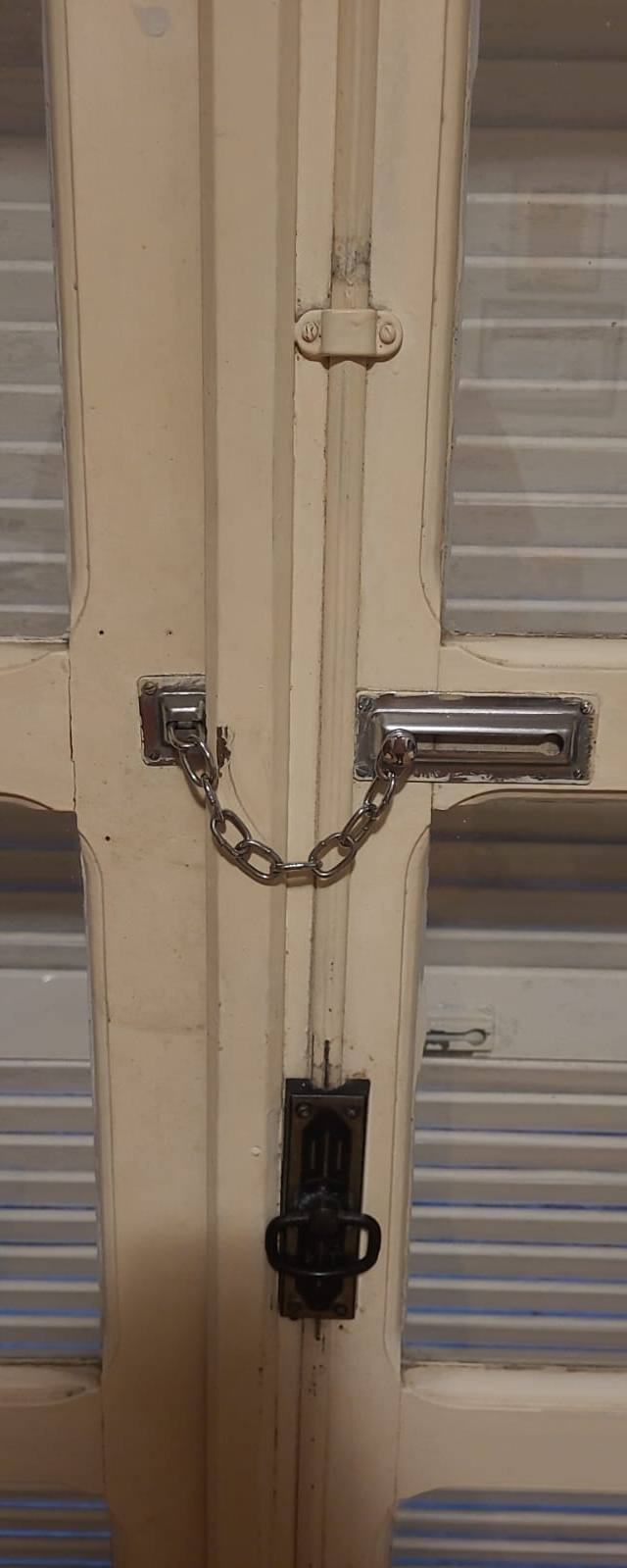 Porta veneziana com vidro e trava de corrente.